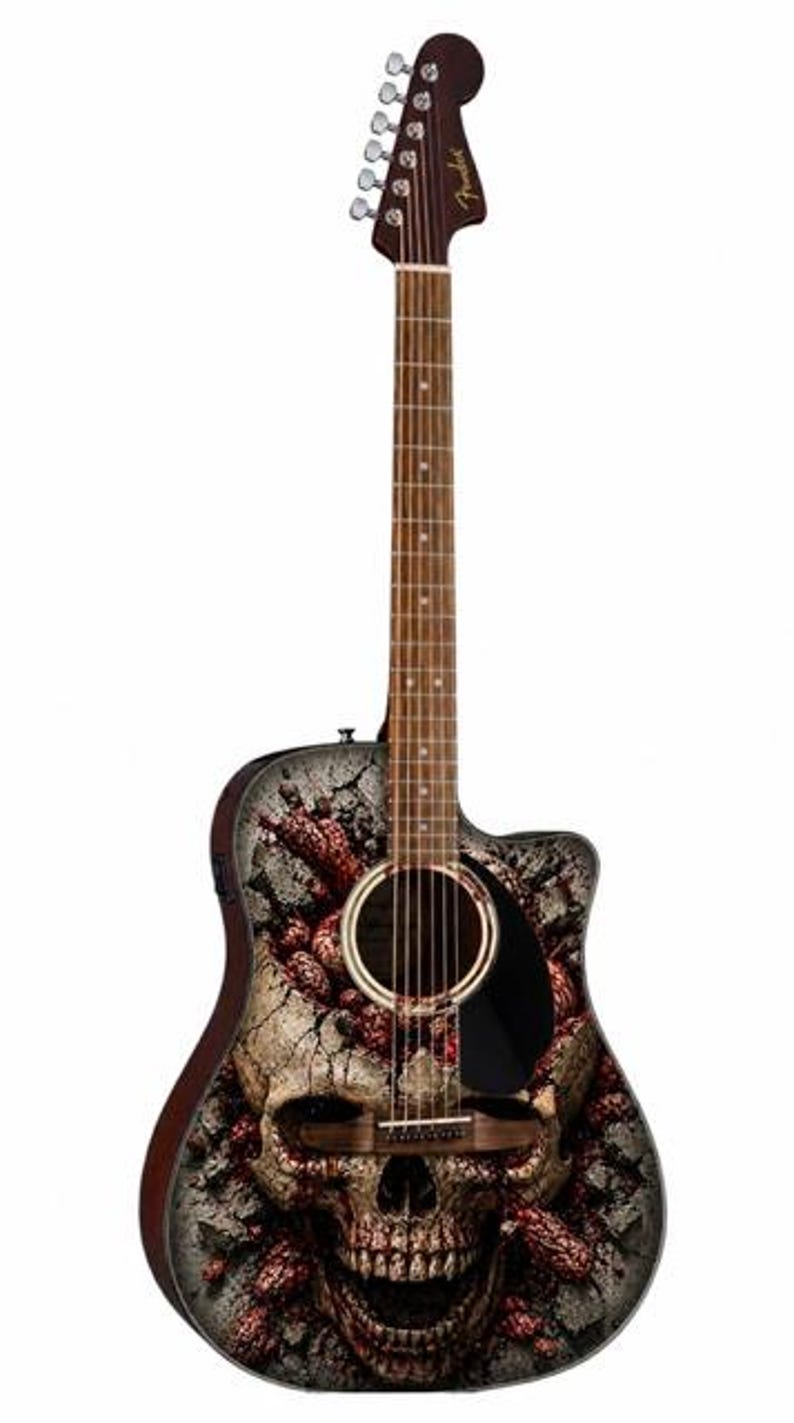 Puede incluir: Guitarra ac&uacute;stica con dise&ntilde;o de calavera. La guitarra tiene m&aacute;stil y clavijero marrones, y un gr&aacute;fico detallado de calavera en el cuerpo. La calavera est&aacute; sobre un fondo agrietado y texturizado con acentos rojos.