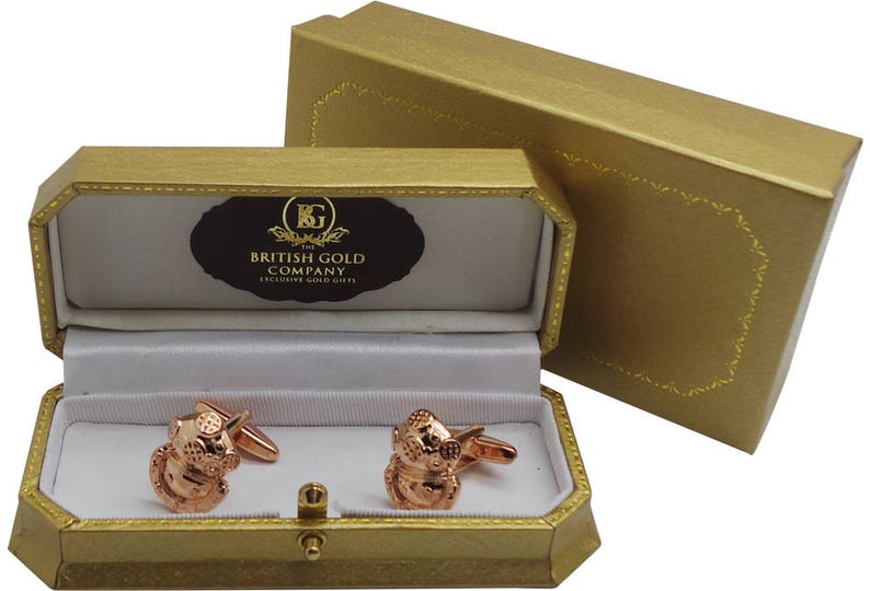May include: A pair of rose gold cufflinks in a gold gift box. The box is lined with white velvet and has the words "The British Gold Company Exclusive Gold Gifts" printed on the inside lid.