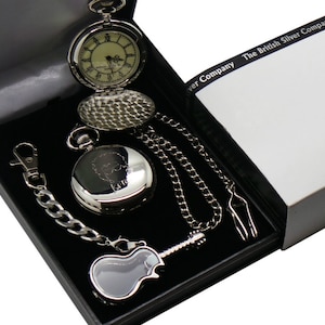 May include: A silver pocket watch with a chain and a guitar-shaped case in a black box with the text "The British Silver Company".