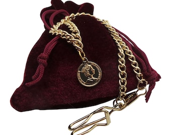 May include: A gold chain with a gold coin pendant and a gold clasp. The chain is in a red velvet pouch.