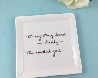 May include: White ceramic dish with a handwritten message in red ink that reads "To my Honey Bunch, -Daddy- The sweetest girl"