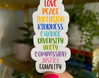 May include: A white sticker with a rainbow design and the words "Love, Peace, Inclusion, Kindness, Change, Diversity, Unity, Compassion, Justice, Equality" in a stacked format.