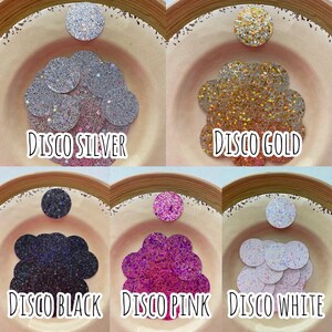 May include: Assortment of six small bowls filled with sparkly glitter in various colors, including silver, gold, black, pink, and white. Each bowl is labeled with the color and the word "Disco".