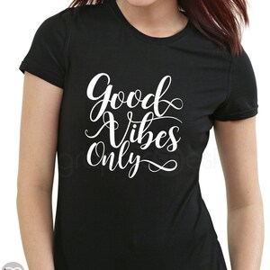 May include: Black t-shirt with white text that reads "Good Vibes Only" in a cursive font.