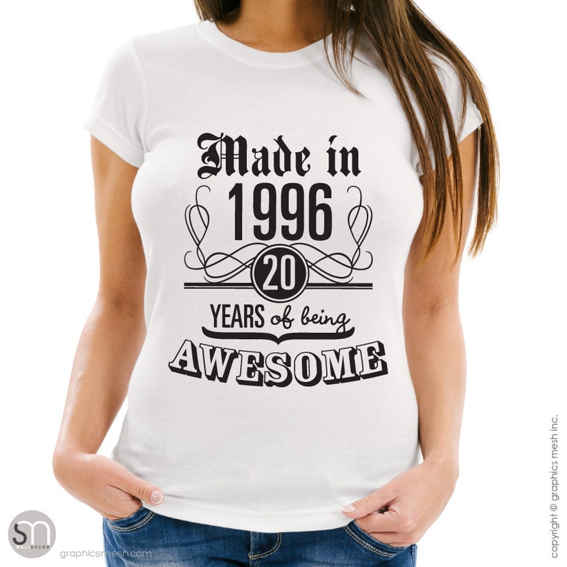 May include: White t-shirt with black text that reads "Made in 1996 20 YEARS of being AWESOME".
