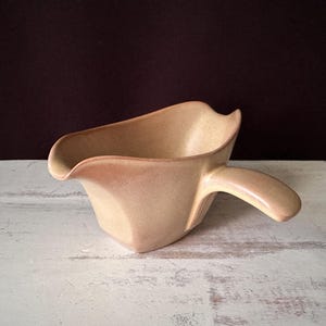 May include: A rustic wooden sign with the text "Welcome to our home" in white lettering. The sign has a distressed finish and a simple, inviting design, suitable for a front porch or entryway.