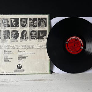 May include: A vintage vinyl record album cover with a photo collage of people smiling. The album title is "Christmas Greetings" and the record label is "Columbia Special Products".