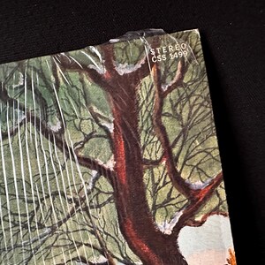 May include: A vintage vinyl record album cover featuring a snowy winter scene with a large tree in the center. The album cover has the text "STEREO CSS 1499" in the upper right corner.