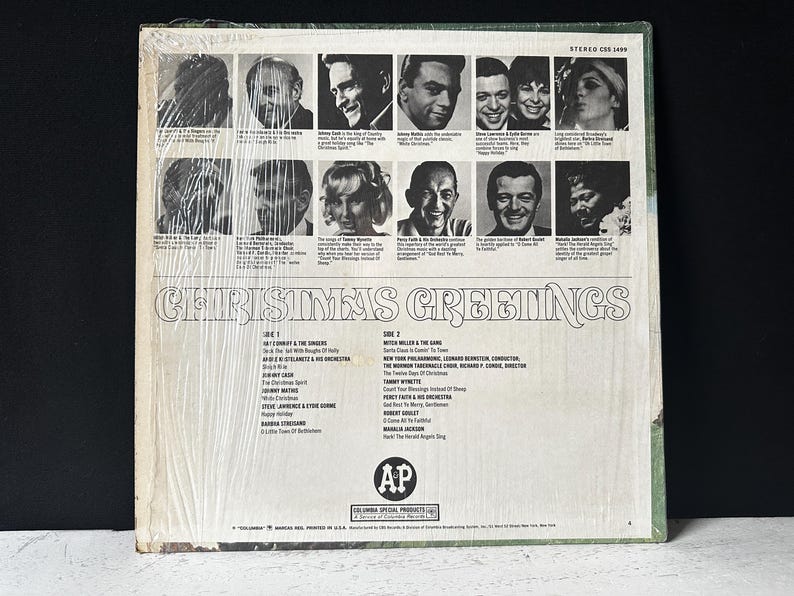 May include: A vintage vinyl record album cover with a white background and a black and white photo collage of singers. The album title is "Christmas Greetings" and the record label is "Columbia Special Products".