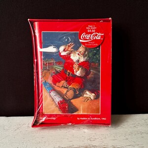 Caixa fechada da COCA-COLA de 1996 com 16 cartões e envelopes de boas-vindas da temporada