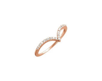 May include: A rose gold ring with a V-shaped design set with small clear diamonds.