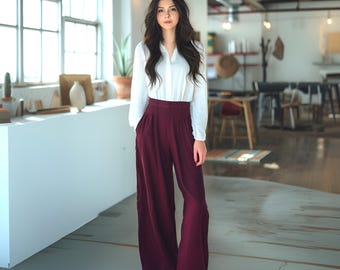 May include: A woman wearing a white long-sleeved blouse with a v-neck and burgundy wide-leg pants.