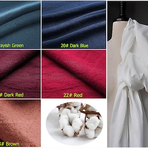 May include: A collection of fabric swatches in various colors, including grayish green, dark blue, dark red, red, and brown. The swatches are labeled with their corresponding color names and numbers. The image also includes a white fabric swatch draped over a mannequin.