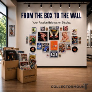 May include: A wall display featuring the text FROM THE BOX TO THE WALL and Your Passion Belongs on Display, showcasing various framed collectibles, vinyl records, and magazines. Two cardboard boxes labeled COLLECTORMONT sit on the floor.
