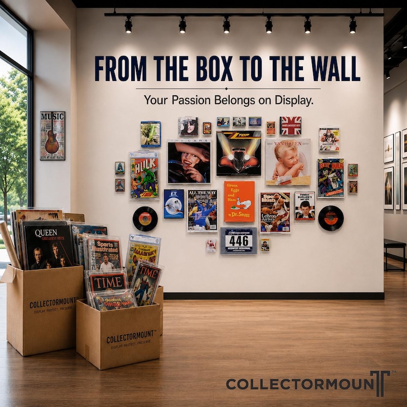 May include: A wall display featuring the text FROM THE BOX TO THE WALL and Your Passion Belongs on Display, showcasing various framed collectibles, vinyl records, and magazines. Two cardboard boxes labeled COLLECTORMONT sit on the floor.
