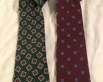 May include: Two silk neckties, one green with a red and white diamond pattern, and one burgundy with a blue square pattern.
