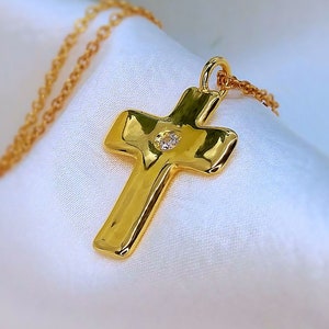 Gold cross with central diamond