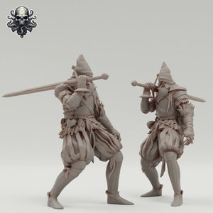 May include: Two gray painted miniature figures of warriors wearing hooded armor and holding swords. The figures are posed in a fighting stance.