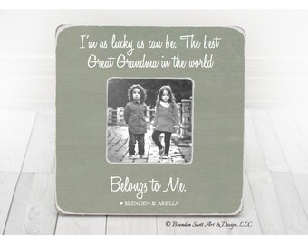 May include: A square, sage green picture frame with rounded corners. The frame holds a black and white photo of two children. White text reads "I'm as lucky as can be. The best Great Grandma in the world." and "Belongs to Me."