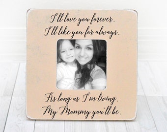 May include: A white wooden picture frame with a light pink background. The frame has a black inscription that reads "I'll love you forever. I'll like you for always. As long as I'm living. My Mommy you'll be."