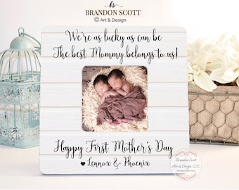 May include: White wooden picture frame with a photo of twin babies inside. The frame has the text "We're as lucky as can be The best Mommy belongs to us! Happy First Mother's Day Lennox & Phoenix" printed on it.