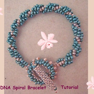 May include: A teal and light brown beaded bracelet with a DNA spiral design. The bracelet is made with small seed beads and has a clasp closure. The text "DNA Spiral Bracelet Tutorial" is visible at the bottom of the image.