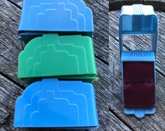 May include: Three vintage ring boxes, one green and two blue, with a velvet interior. The boxes are stacked on top of each other. The top box is open and shows the velvet interior.