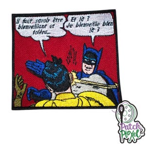 May include: Embroidered patch featuring Batman and Robin in a comic book style scene. Batman is slapping Robin's head and saying "Et là? Je blenvelle blen là?" Robin is saying "Il faut savoir être blenvelliant et toléra..."