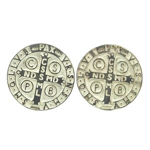 May include: Two silver-colored Saint Benedict medals with black lettering. The front of each medal features a cross with the letters 'C.S.S.M.L.' and 'N.D.S.M.D.' around the cross. The back of each medal features the words 'PAX' and 'VBS' around the edge.