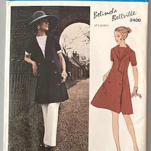 May include: Vogue Couturier Design sewing pattern 2400 by Belinda Bellville of London. The envelope features a photograph of a double-breasted coat worn over white trousers and an illustration of a double-breasted dress with short sleeves and a collar.