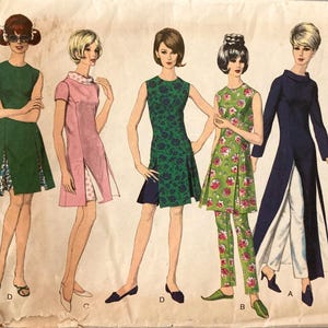 May include: A vintage sewing pattern envelope illustration featuring five different dress and tunic designs. The garments include a green dress, a pink dress with a polka dot collar, a green floral dress, a floral tunic with matching trousers, and a long navy blue tunic with white trousers.