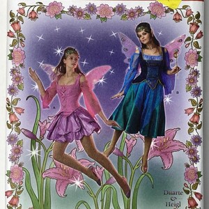 May include: Simplicity sewing pattern 2857 for costumes in sizes RR 14, 16, 18, 20. The package features illustrations of two fairy costumes with wings, one in pink and purple and one in blue and teal, surrounded by a floral border on a purple background.