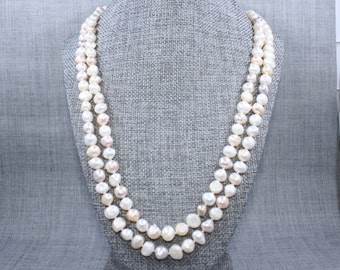 Hand knotted continuous strand of white, peach and mauve fresh water pearls