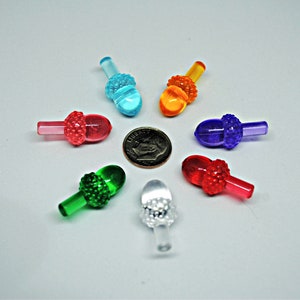 May include: Assortment of eight acorn-shaped Christmas tree ornaments in various colors, including red, green, blue, purple, orange, and clear. The ornaments are approximately 1 inch in size.