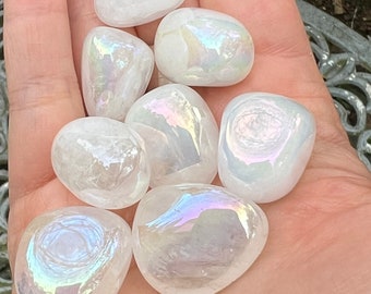 May include: Seven iridescent white tumbled stones with a rainbow sheen. The stones are smooth and polished.