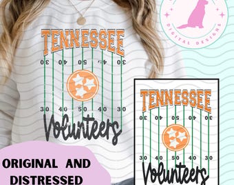 May include: White sweatshirt with a distressed design. It features the word "TENNESSEE" in orange, a football field graphic, and the word "Volunteers" in black. The design includes the Tennessee Volunteers logo.