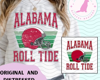 May include: White sweatshirt featuring the word "ALABAMA" in red block letters above a distressed red football helmet. Below the helmet, the words "ROLL TIDE" are in red block letters. A smaller graphic of the design is also visible.