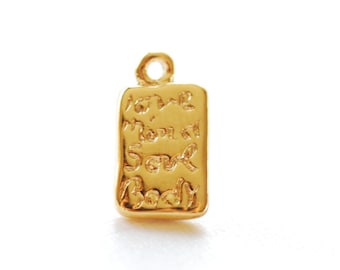 May include: Gold charm with a rectangular shape and a textured surface. The charm has an inscription that reads "And then I saw you".