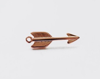 May include: A rose gold arrow charm with a loop at the top for attaching to jewelry or other crafts.
