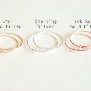 May include: Three pairs of hoop earrings in different finishes: 14k gold filled, sterling silver, and 14k rose gold filled.