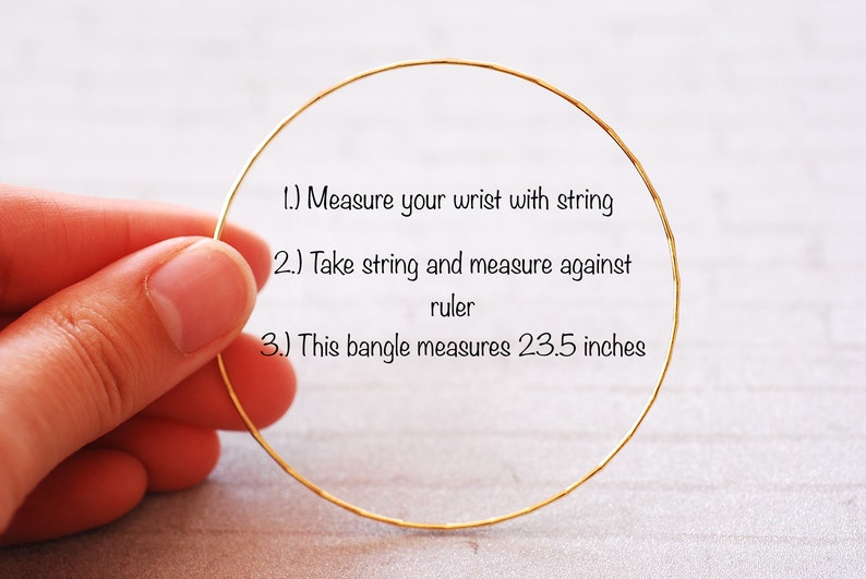 May include: A gold bangle bracelet with instructions on how to measure your wrist for the perfect fit. The bangle measures 23.5 inches in circumference.