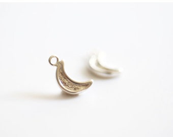 May include: Two silver crescent moon charms with a loop for attaching to jewellery.