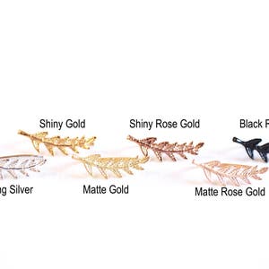 May include: Seven leaf-shaped earrings in different finishes: sterling silver, shiny gold, matte gold, shiny rose gold, matte rose gold, and black rhodium.