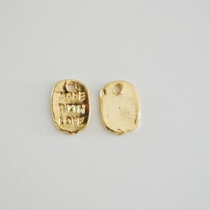 May include: Two gold-coloured metal tags. One tag is blank, the other tag says "Made with Love".
