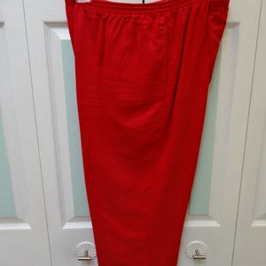 May include: A pair of red, wide-leg trousers with a straight hem.