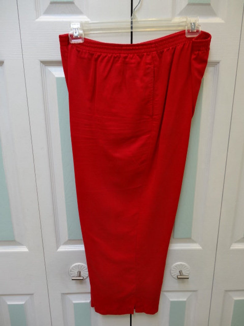 May include: A pair of red, wide-leg trousers with a straight hem.