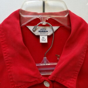 May include: Red button-down shirt with a white label that says "AKS Amy K.S. Dresses" and "XL Made in Vietnam". The shirt has a small embroidered chili pepper design.