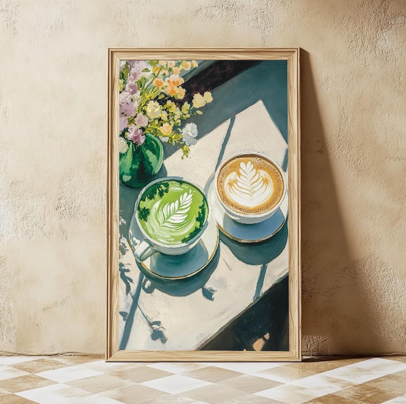 May include: A painting of two cups of coffee on a white table. One cup is filled with green matcha latte and the other with brown coffee. Both cups have latte art. The table is decorated with a bouquet of flowers in a green vase.