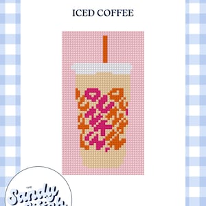 May include: A cross-stitch pattern featuring a beige iced coffee cup with a white lid and orange straw on a pink background. The cup displays the text "DUNKIN" in orange and pink pixelated letters. The words "ICED COFFEE" appear above the cup.