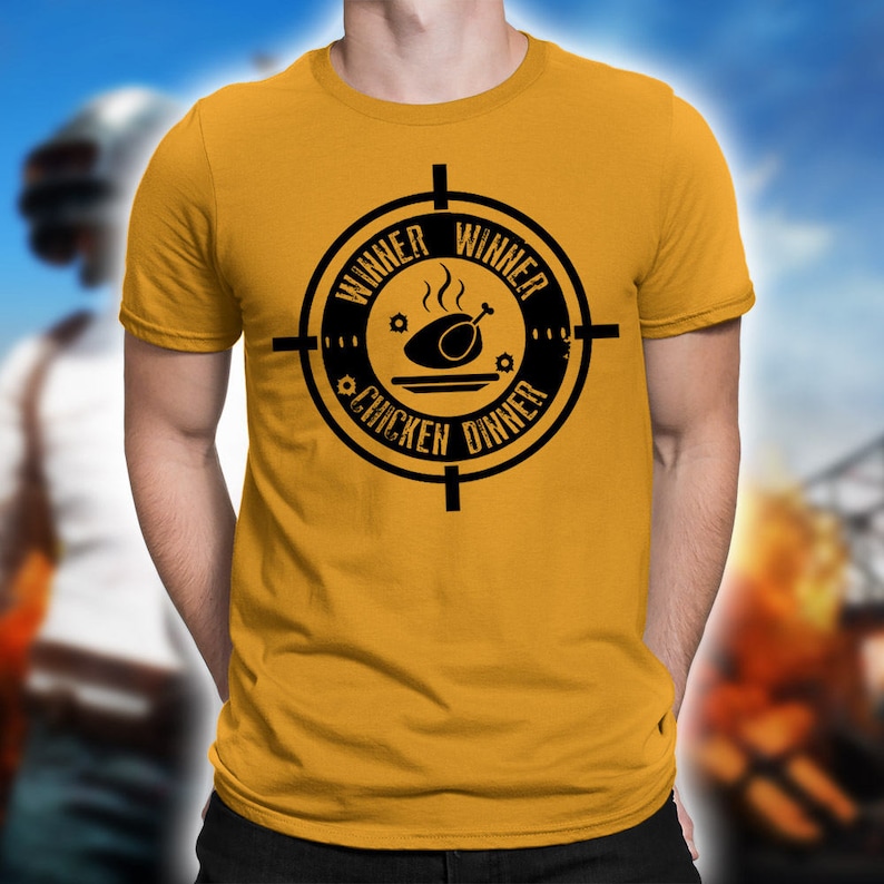 May include: A yellow t-shirt with a black graphic of a chicken dinner inside a target with the text "Winner Winner Chicken Dinner".